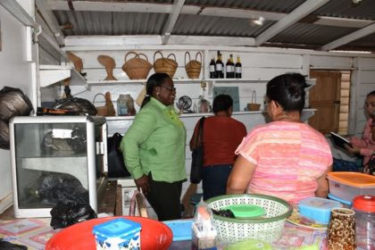 Minister in the Ministry of Natural Resources (left), Simona Broomes meeting with the women’s group of Moruca, Region One in their craft shop (GINA photo)