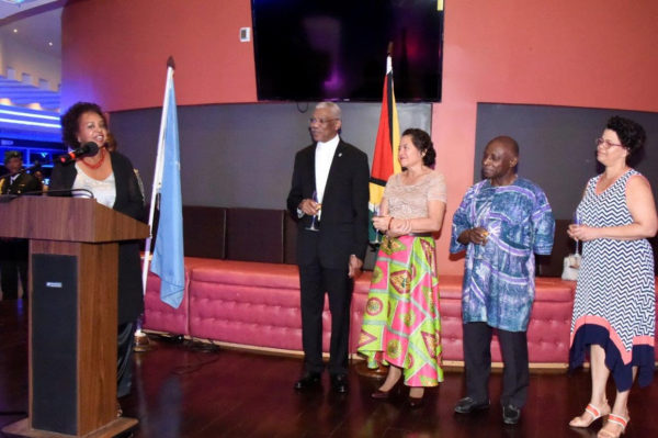 Outgoing United Nations Representative in Guyana, Khadija Musa (left) makes a point to President David Granger (second from left), during her brief remarks on Friday evening. (Ministry of the Presidency photo)