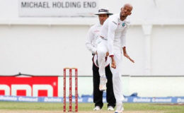 Roston Chase sends down a delivery during his five-wicket haul against India during the second Test at Sabina Park. 