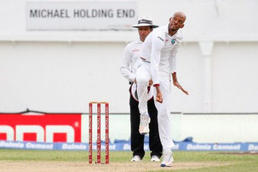 Roston Chase sends down a delivery during his five-wicket haul against India during the second Test at Sabina Park. 