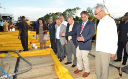 President David Granger, together with Gaico's CEO, Komal Singh and other dignitaries examining the equipment that would be used to skim the oil during a spill
