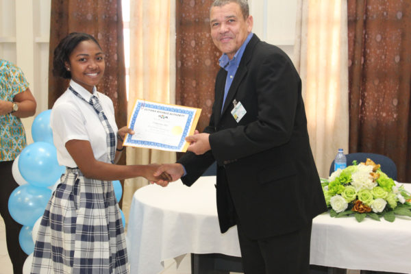 Commissioner-General of the GRA Godfrey Statia presenting a certificate of participation to Tatyana Ali (GRA photo)