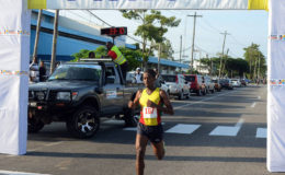 SIX IN A ROW! Cleveland Forde cruising across the finish line yesterday to win his sixth consecutive Massy 10k event. (Orlando Charles photo)
