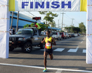 SIX IN A ROW! Cleveland Forde cruising across the finish line yesterday to win his sixth consecutive Massy 10k event. (Orlando Charles photo) 