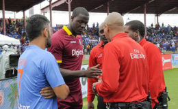 India captain MS Dhoni (left) discusses the abandoned T20 International with West Indies captain Carlos Brathwaite and match officials. (Photo courtesy WICB Media)