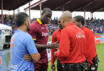 India captain MS Dhoni (left) discusses the abandoned T20 International with West Indies captain Carlos Brathwaite and match officials. (Photo courtesy WICB Media)