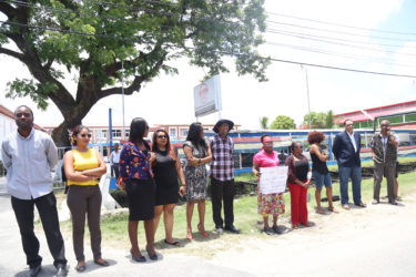 Some members of the media and civil society protesting outside of the NCN compound on Homestretch Avenue. 