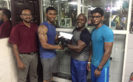 Senior trainer at Buddy’s Gym, Mervyn ‘Spongy’ Moses recently presents a cheque to Dmitry Chan ahead of the Raw National Championships on September 18 at the Critchlow Labour College.