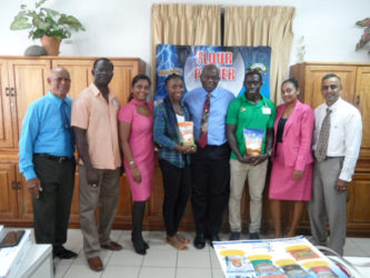 Winston George (third from right) and Alita Moore (fifth from right) pose with the top brass of NAMILCO following the presentation on Tuesday.