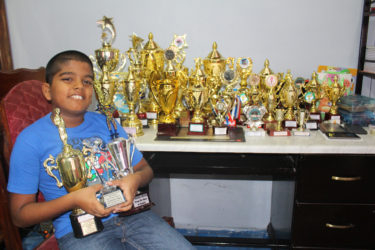  Yovendra ‘Nyan’ Singh poses with his 28 trophies