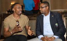 A CIVIL MOMENT: WICB president Dave Cameron (right) chats with outspoken Twenty20 star Dwayne Bravo during the recent players symposium in Florida. Bravo has in the past criticised Cameron’s leadership.