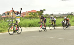 Junior Niles powering across the line to record his first victory of the 2016 season yesterday at West Demerara. (Orlando Charles photo)