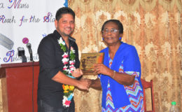 Ramnaresh Sarwan receives the plaque from his former Headmistress at Stella Maris `Primary School, Mrs Natalie Author.
