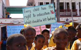 No child left behind: Students assembled with placards emphasising the importance of education yesterday at the Stabroek Square, from where they marched to D’Urban Park for the Education Month rally.  President David Granger used the event yesterday to inaugurate an annual Education Day.  (Photo by Keno George)