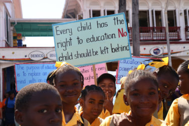 No child left behind: Students assembled with placards emphasising the importance of education yesterday at the Stabroek Square, from where they marched to D’Urban Park for the Education Month rally.  President David Granger used the event yesterday to inaugurate an annual Education Day.  (Photo by Keno George)