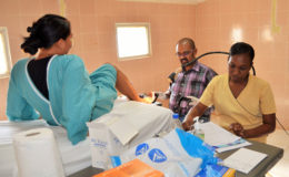 Dr. Sayan Chakraborty and a nurse from CIG prepare to do a Pap smear on a patient