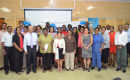 Country Manager Deo Persaud (third from left in front row) and senior managers pose with representatives of the 24 organisations. (Massy photo)