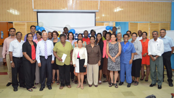 Country Manager Deo Persaud (third from left in front row) and senior managers pose with representatives of the 24 organisations. (Massy photo)