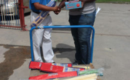 Joel Alleyne, right, of the Malteenoes Cricket Club receives the equipment from Food for the Poor’s Wayne Hamilton.