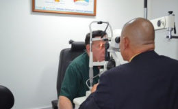 Minister of Public Health, Dr. George Norton performs an Ophthalmology examination on Dr. Philip Da Silva (GINA photo)