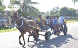 Children enjoying a horse cart ride home from school, escaping the minibus blues (Photo by Keno George)