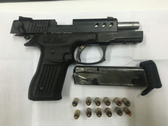 The unlicensed 9mm pistol with 12 matching rounds of ammunition that were found during the search. (Police photo)