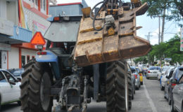 This tractor with a part hanging out dangerously, was seen travelling through the busy town by the Berbice Minibus/Hire Car Park today. It posed a hazard to pedestrians and other road users