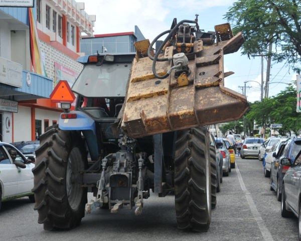 This tractor with a part hanging out dangerously, was seen travelling through the busy town by the Berbice Minibus/Hire Car Park today. It posed a hazard to pedestrians and other road users