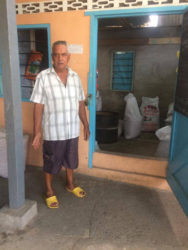 Neville Sooklall standing next to the shop where his daughter-in-law was stuck up by one of the bandits. 