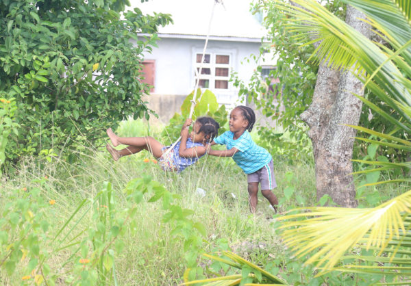 Photographer Keno George snapped these two children at play on a makeshift swing amidst an overgrowth of vegetation in ‘E’ Field, Sophia yesterday. 