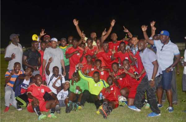 The victorious Guyana Police Force (GPF) outfit along with alongside several of their supporters following their unlikely 2-0 win over the much fancied Western Tigers in the final of the Mayor’s Cup Football Championship at the Tucville Community ground Sunday.