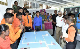 President David Granger and First Lady Sandra Granger listen as Mr. Raj, the instructor of the Electrical Installation Course, explains some of the features of the programme.  (Ministry of the Presidency photo)