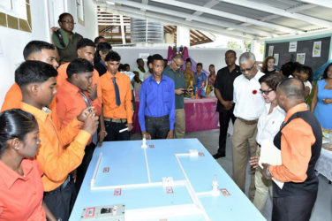 President David Granger and First Lady Sandra Granger listen as Mr. Raj, the instructor of the Electrical Installation Course, explains some of the features of the programme.  (Ministry of the Presidency photo) 