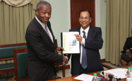 Auditor General Deodat Sharma (right) presents Speaker of the National Assembly Dr Barton Scotland with the 2015 Auditor’s General’s Report. (Photo by Keno George)
