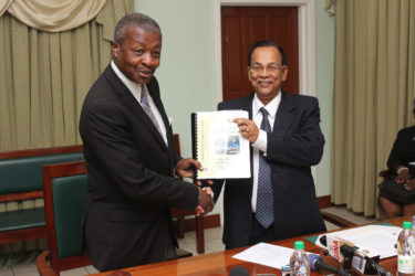 Auditor General Deodat Sharma (right) presents Speaker of the National Assembly Dr Barton Scotland with the 2015 Auditor’s General’s Report. (Photo by Keno George)