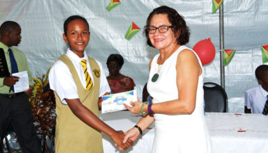 Top East Coast student, Aletha Joseph receives her award from First Lady,  Sandra Granger.  (Ministry of the Presidency photo) 