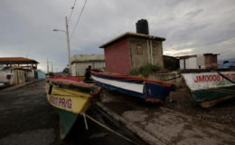Boats are secured along a street as a resident looks on at Port Royal while Hurricane Matthew approaches, in Kingston, Jamaica October 2, 2016. REUTERS/Henry Romero
a