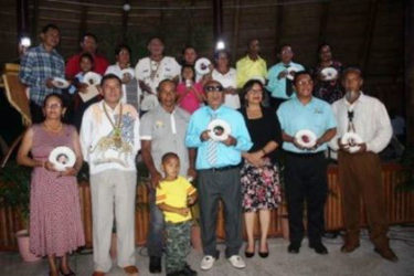 Minister of Indigenous Peoples Affairs Sydney Allicock, (second from left in front row) with Minister within the Ministry of Indigenous Peoples Affairs, Valerie Garrido-Lowe (third from right in front row) along with the 18 persons who were honoured.