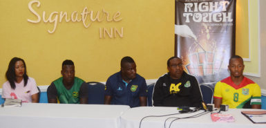 Members of the head table at yesterday’s press briefing. Golden Jaguars captain Chris Nurse is at right while Guyana Head-Coach Jamaal Shabazz is second from right), Jamaica Head-Coach Theodore Whitmore is at centre and Reggae Boyz Captain Jevaughn Watson second from left. (Orlando Charles photo)