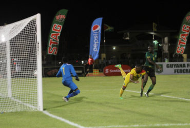 Adrian Butters of Guyana (yellow) in the process of scoring his team’s second goal with a header during their match against Jamaica in the CFU Caribbean Cup Qualifiers at the National Track and Field Centre in Leonora. (Orlando Charles photo)