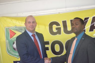 Deal sealed-recently appointed GFF Technical Director Englishman Ian Greenwood (left) shaking hands with GFF Chief Wayne Forde following the conclusion of his first press conference to signal his start to life in Guyanese football 