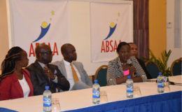 ON BOARD! Minister within the Ministry of Education Nicolette Henry addressing the gathering at the Pegasus Hotel in Kingston while members of the ABSAA including  Alex Bunbury (third from left) and NSC Chairman Ivan Persaud (left) look on.