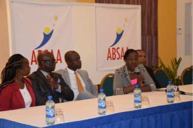 ON BOARD! Minister within the Ministry of Education Nicolette Henry addressing the gathering at the Pegasus Hotel in Kingston while members of the ABSAA including  Alex Bunbury (third from left) and NSC Chairman Ivan Persaud (left) look on.