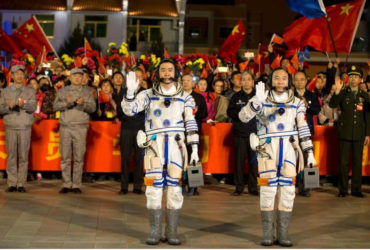 Chinese astronauts Jing Haipeng (R), Chen Dong wave before the launch of Shenzhou-11 manned spacecraft, in Jiuquan, China, October 17, 2016. China Daily/via REUTERS 