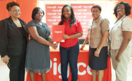 From left to right are Administrator (ag) of the National School of Theatre, Arts and Drama Margaret Lawrence, Director of Culture (ag) Tamika Boatswain, Digicel's Sponsorship Executive Louanna Abrams, Drama Coordinator of the Unit of Allied Arts Loraine Barker-King and Lavon George. In photo, Boatswain receives Digicel’s contribution for the festival from Abrams. (Digicel photo)