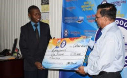 Human Resource, Executive Director of GPL, Bal Parsaud presenting cheque of $100,000 to Representative for Edussential Company, Mark Stevens (right)