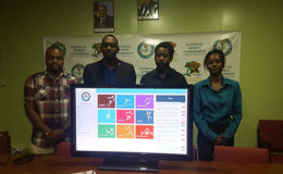 Director of Sports Christopher Jones (2nd from left) displaying the National Athletes Database alongside Assistant Director of Sport Melissa Richardson (right), Commissioner Edison Jefford (left) and Intellect Storms’ Information Systems Architect Rowen Willabus
