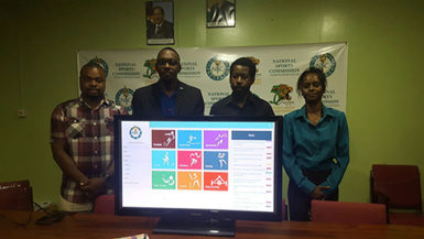 Director of Sports Christopher Jones (2nd from left) displaying the National Athletes Database alongside Assistant Director of Sport Melissa Richardson (right), Commissioner Edison Jefford (left) and Intellect Storms’ Information Systems Architect Rowen Willabus 