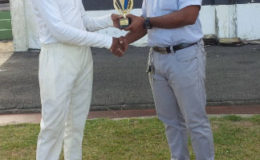 GCB’s Anthony D’Andrade presents the winning trophy to Friendship skipper Orlando Ghisiawan.

