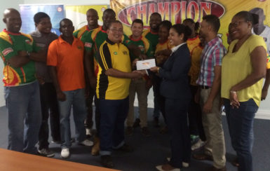 President of the GRFU, Peter Green is all smiles as he receives the financial pact from Edward B. Beharry and Company’s Brands Manager, Kamini Naresh yesterday. Green and Naresh are flanked by players and officials of the union.